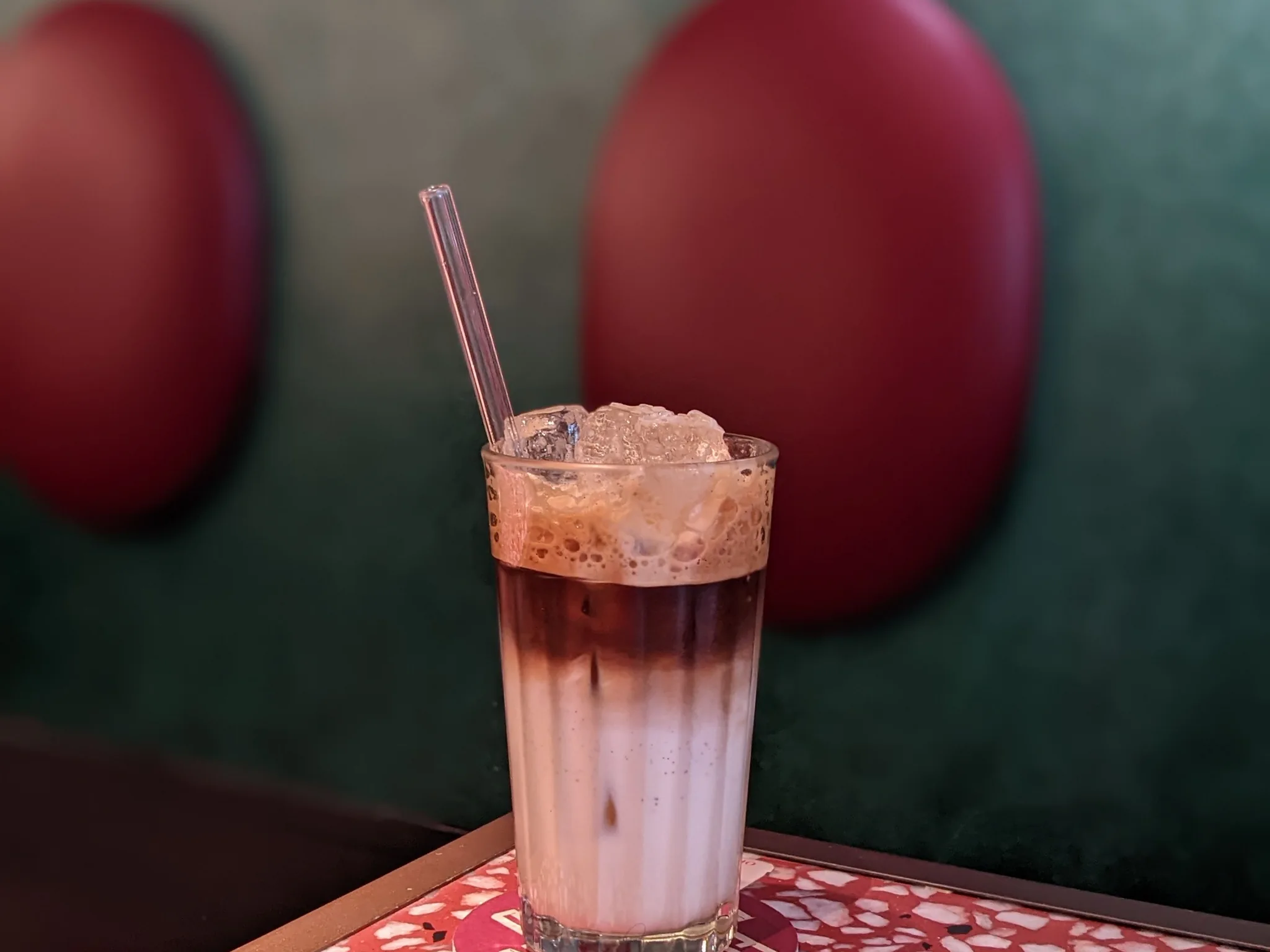 An iced latte on a patterned café table in Ho Chi Minh City
